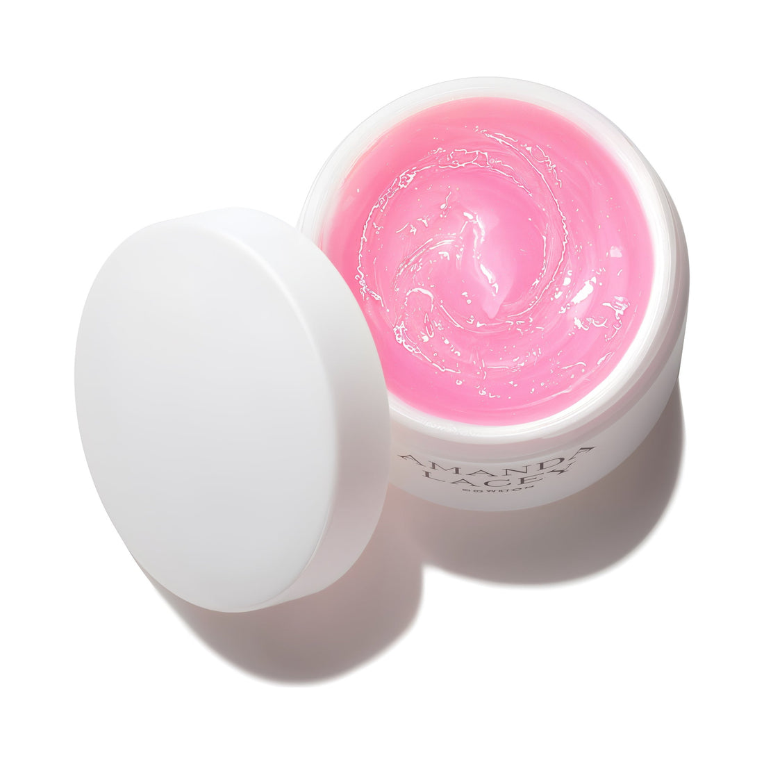 Amanda Lacey Revealing Pink Mask, open white jar of pale pink gel with lid beside it