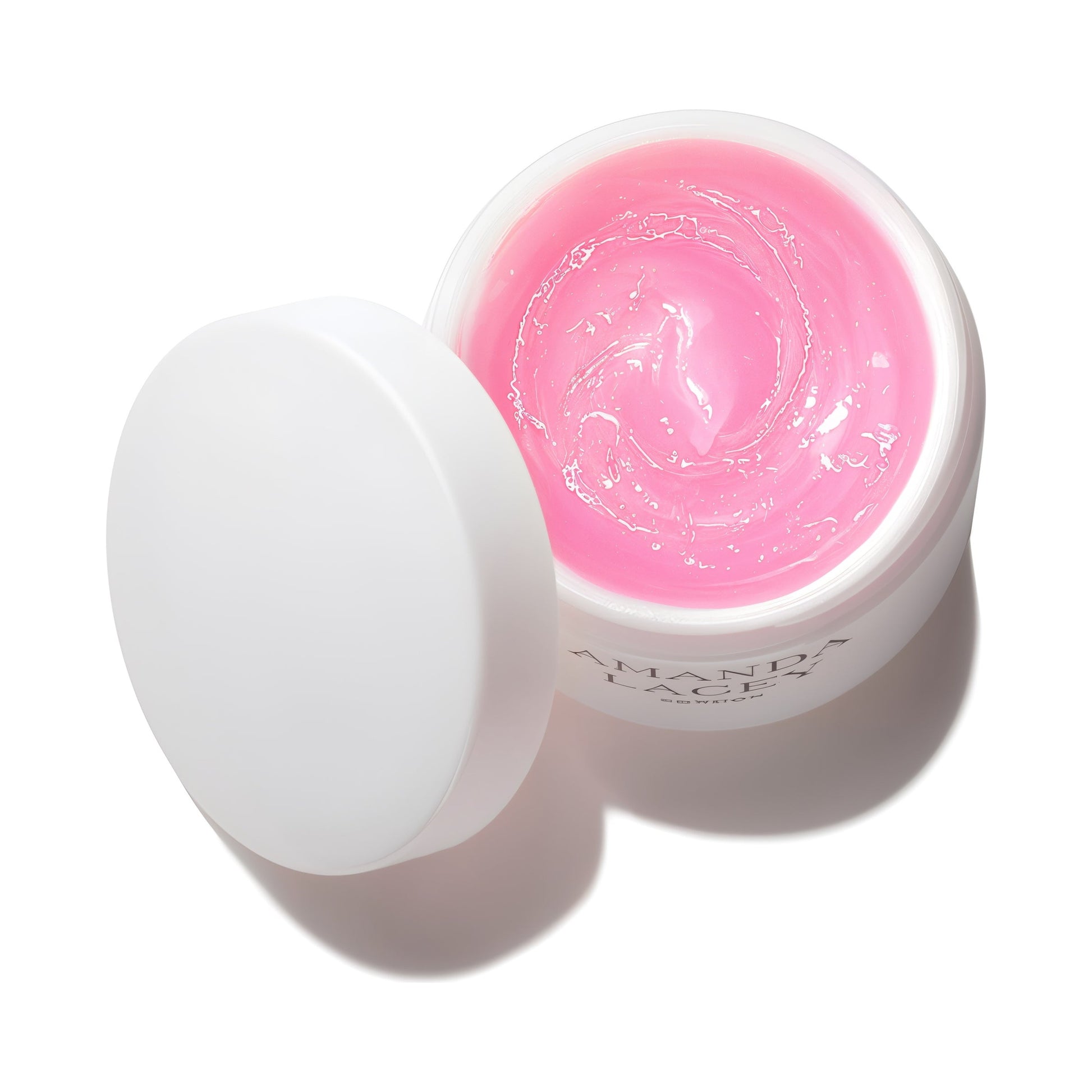 Amanda Lacey Revealing Pink Mask, open white jar of pale pink gel with lid beside it